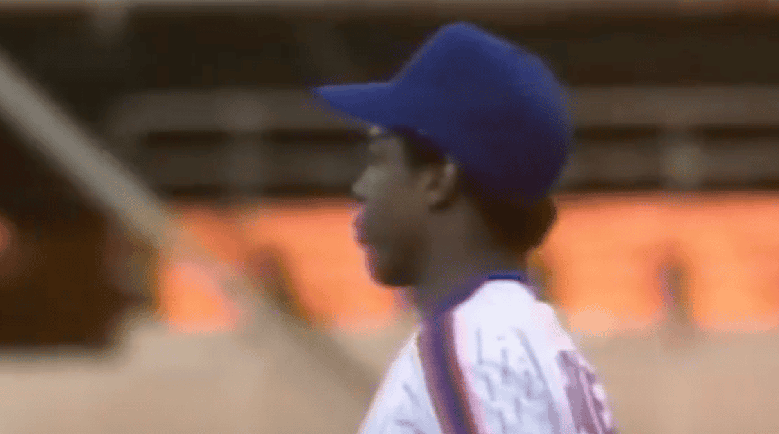 Dwight Gooden pitching during his 1984 MLB rookie season, showcasing dominance.